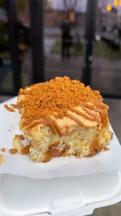 Assorted pastries and sandwiches from top UK bakeries: croissants, pain au chocolat, cinnamon rolls, focaccia, and more.