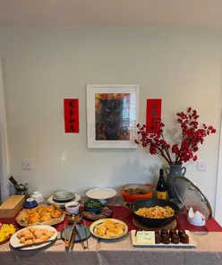 Lantern Festival celebration with friends, featuring homemade dishes, stir-fried noodles, and rice ball soup in a warm atmosphere.