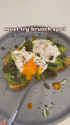 Brunch at Junction MCR: yogurt bowl, bacon barm, avocado toast, salmon bagel, and pastries in a cozy cafe.
