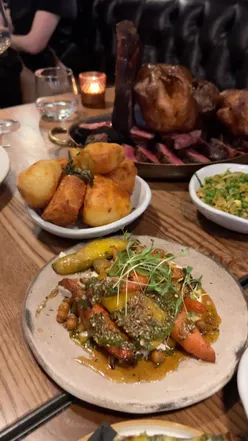 Delectable Sunday roast dinner at Pasture Cardiff, featuring succulent steak, in a cozy Cardiff city center setting.