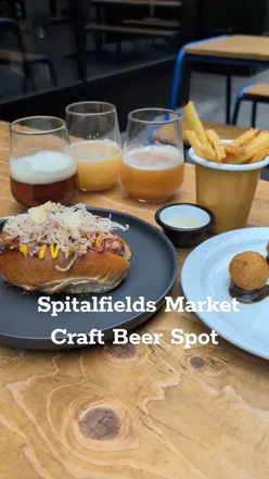 Craft beer selection at Old Spitalfields Market with burgers, fries, and Welsh rarebit croquettes.