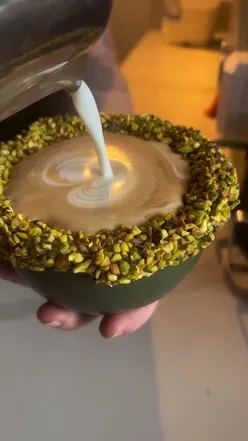 Barista preparing signature cappuccinos with pistachio and chocolate rims at Francies Focaccia in Liverpool.