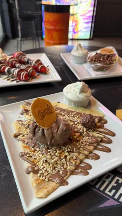 Delicious cookie dough and desserts at Creams Cardiff, featuring vibrant treats and a refreshing menu.