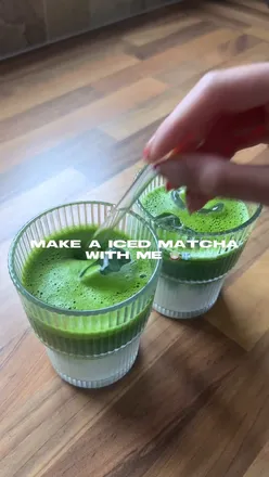 A vibrant green matcha latte in a glass, showcasing its rich color and creamy texture, perfect for breakfast or a pick-me-up.