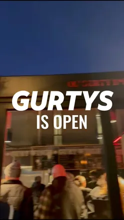 Group enjoying chicken wings at Gurt Wings' new Wapping Wharf spot, featuring crispy fried and garlic wings, Bristol.