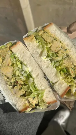 Delicious The Chapo sandwich with chicken, chimichurri mayo, and fresh ingredients at Milk Buns Deli.
