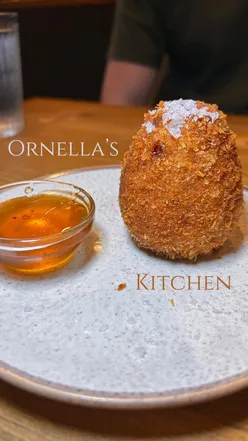 Delicious dishes from Ornella's Kitchen: arancini, carbonara, lamb ragรน, and beef short rib with gnocchi.