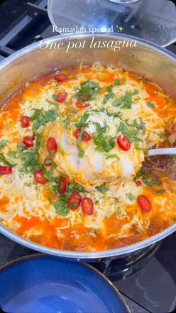 One pot beef lasagna with ground beef, lasagne sauce, Bechamel, mozzarella, cheddar, garnished with coriander and red chili.