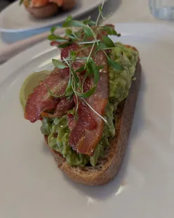Epic breakfast at Boscanova, Boscombe: Avocado toast with bacon and potato hash; scrambled eggs on toast with salmon and halloumi.