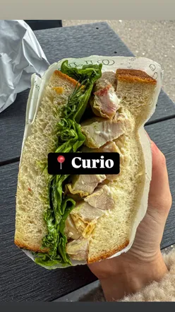 Delicious chicken and beef sandwiches on fresh bread at Curio Cafe Bar in Brighton, perfect for foodies.