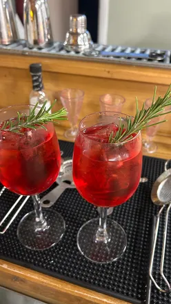 Group enjoying mocktail making class at Liquor Studio Leeds, featuring colorful drinks and fresh ingredients.