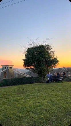Stunning sunset over Clifton Suspension Bridge in Bristol, highlighting golden skies and vibrant colors.