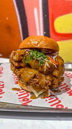 Double stacked Katsu burger and 48 wings with Thai pesto, salt & pepper hot honey, Gochujang buffalo, blue cheese, pineapple Mexican Salsa Macha & lime at Mollis Fried Chicken.