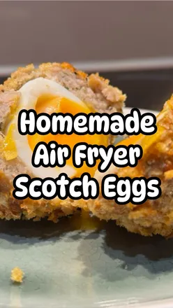 Delicious air fryer Scotch eggs wrapped in sausage, coated in Panko, served with ketchup and brown sauce.