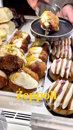 Delicious ลผeppoli pastries filled with ricotta, topped with icing sugar and pistachios, enjoyed in Rabat, Malta.