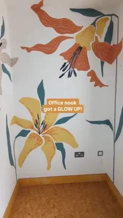Brightly painted lily mural in a cozy office nook with a stylish desk for work and creativity.