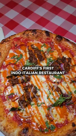 Delicious Indo-Italian dishes at Stella Italia, including calzone, pasta, and cocktails in Cardiff.