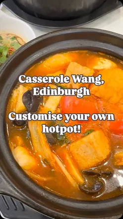 Veggie hotpot with tofu, Korean rice cakes, and mushrooms in tangy tomato broth at Casserole Wang, Edinburgh.