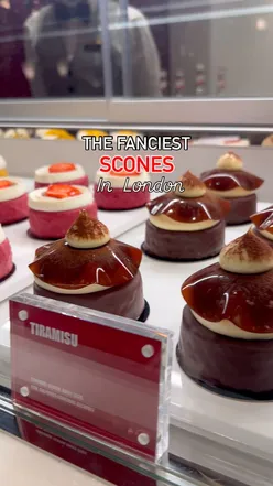 Luxurious scones at Scoff, The Savoy London, featuring strawberry, mango, and salted caramel popcorn flavors.