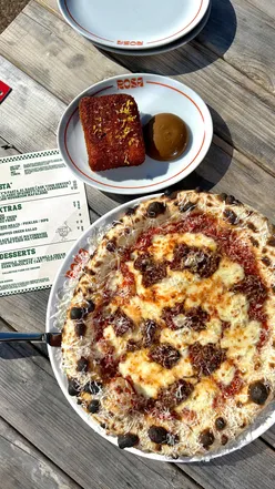 Deep fried lasagne with rich tomato sauce and black garlic mayo, alongside a beef ragu pizza at Rosa NQY.