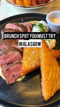 Delicious brunch at Kudos in Glasgow featuring steak and eggs with crispy hash browns and spicy breakfast potatoes.