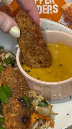 Delicious salt and pepper tenders with curry sauce served over rice and stir-fry vegetables, perfect for weight loss.