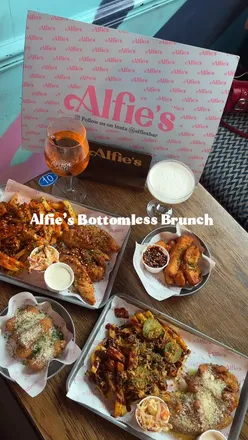 Two plates of chicken tenders with garlic Parmesan and hot honey at Alfie's Bar's bottomless brunch in Newcastle.