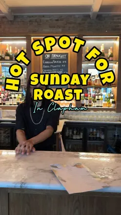 Delicious Sunday roast dishes including scallops, beef, and vegetarian options at a cozy Clapham gastropub.