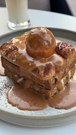 Delicious tiramisu French toast topped with honey at Hampstead Bakery and Cafe in Dubai.