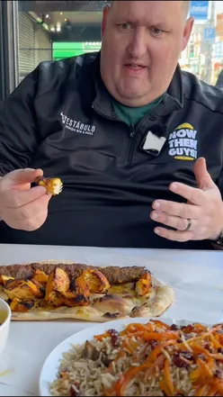 World famous kobeda kebab on a plate with fresh salad and naan bread