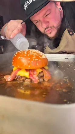 DIY Libertine Burger kit with ingredients, apron, and cooking instructions for a delicious homemade burger.