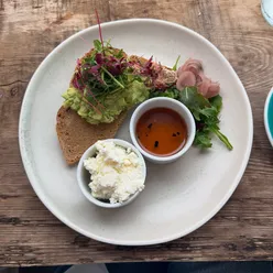 Smashed avocado with whipped feta and a flat white at Burra in Clifton Village, Bristol.