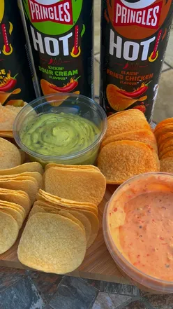 Enjoying Pringles' Blazinโ Fried Chicken, Kickinโ Sour Cream, and Flaminโ Cheese flavors with dips.