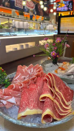 Delicious hot pot meal with vibrant meat and seafood platters at Happy Lamb Edinburgh, perfect for food lovers.