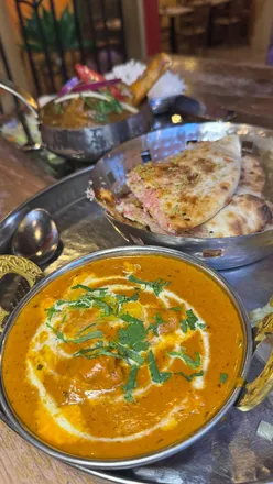 Delicious Indian dishes at Indian Tiffin Room: prawn kebab, Dahi Puri, Nalli Nihari, and Butter Chicken with naan.