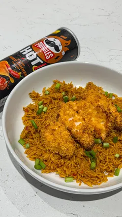 Crispy Pringles-coated chicken served with peri peri rice and spicy mayo, showcasing a delicious hot meal.