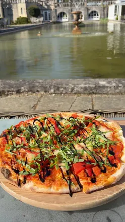 Chorizo and pepper pizza with skinny fries and gin lemonade at Rhinefield House Hotel on a sunny afternoon.