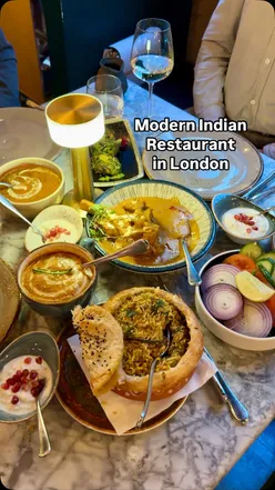 Family dinner at 1947 London featuring flavorful Indian dishes like lamb shank, biryani, and butter chicken.