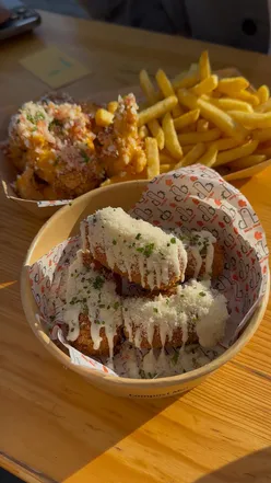 Enjoying street food from Dirty Bird Fried Chicken and Brasco's Burgers with a Pina Colada at Tiger Yard Cardiff.