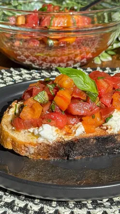 Delicious bruschetta topped with creamy buffalo mozzarella and fresh heritage tomatoes, perfect for summer meals.