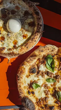Delicious Genovese pizza with slow-cooked beef, smoky mozzarella, and cherry negroni cocktail at Pizza Pilgrims.