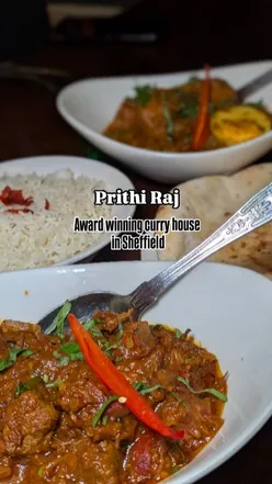 Delicious Indian curries and starters at Prithiraj Restaurant, featuring sizzling prawns and lamb dishes.