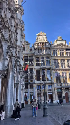 Two friends enjoying Belgian chocolate and mini waffles in Brussels, with the Grand Place in the background.