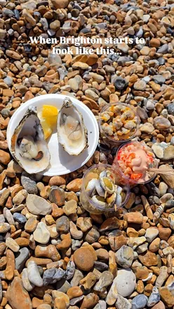 A sunny seaside scene in Brighton with delicious summer food and drinks, perfect for foodies enjoying the beach.