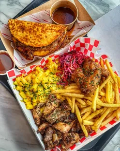 Trinity Kitchen Leeds vendor lineup: Jimmy Macks' beef brisket tacos, Dutty Scran Van's Big Tings Munch Box with jerk chicken, fries, and more.