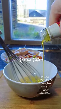 Fresh spring salad topped with homemade dressing made with PGFY olive oil, perfect for healthy eating.