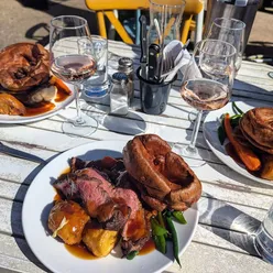 Brighton's best Sunday roast with garlic rosemary roasties at Ladies Mile pub, featuring perfectly cooked elements.