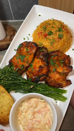Delicious Nando's fakeaway meal featuring spicy chicken and sides, perfect for a cozy night in.