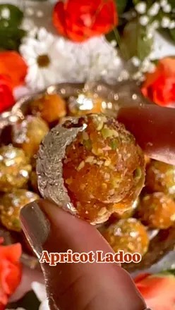 Apricot ladoos with pistachios and silver leaf, made from dried apricots and orange juice, perfect spring dessert.