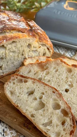 Freshly baked white bread boule, perfect for sandwiches and brunch, showcasing rustic texture and flavor.